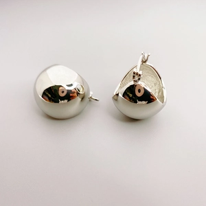 Minimalist silver hemisphere hoop earrings with high-polished mirror finish surface