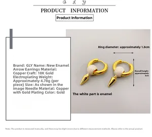 Macro shot showing dimensions and weight of 18K gold-plated white enamel bullet earrings