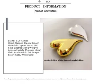 Polished heart brooch details with dimensions of 5.25x3.55cm and 18K gold plated brass
