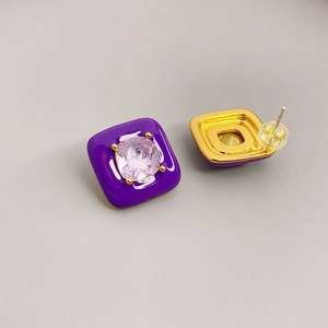 Detailed view of square enamel earrings with purple gemstone and 18K gold-plated base