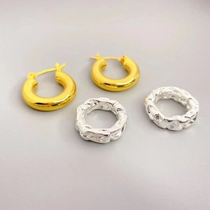 Mixed gold and silver chunky hoop earrings with smooth and twisted texture finish