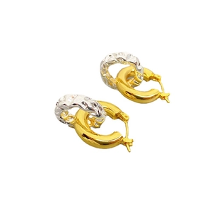 Interlocked gold and silver textured hoop earrings in a mixed-metal twisted design