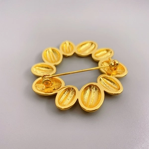 Golden sunflower brooch in 18K gold plated brass showing back view and safety pin