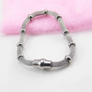 Silver mesh woven stainless steel bracelet with magnetic clasp on pink background