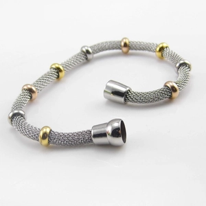 Detailed macro view of woven stainless steel mesh bracelet with multi-color beads