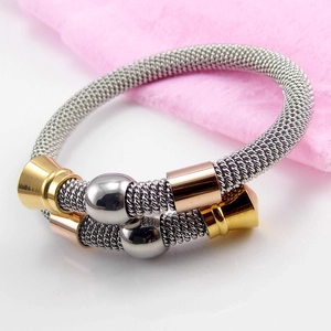 Detail of twisted spring cable bracelet featuring gold and rose gold cylindrical sliders
