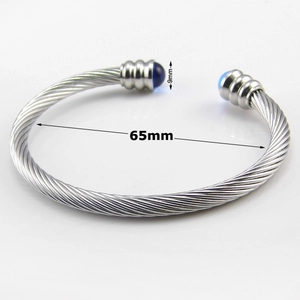Detail of cable texture stainless steel bracelet with 65mm inner diameter measurement