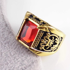 Close-up of vintage gold stainless steel ring featuring a large rectangular red gemstone