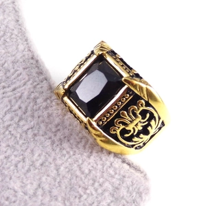 Macro shot of men's vintage gold ring with rectangular black onyx and side carvings