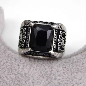 Macro shot of vintage silver men's ring with a large rectangular black stone and leaf relief