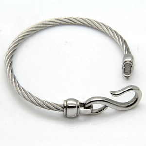 Detail of silver twisted cable stainless steel bracelet with polished S-hook closure