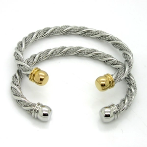 Detailed macro view of twisted cable wire cuff bracelets with metallic rope texture