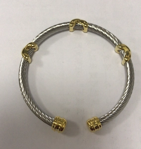 Two-tone stainless steel cable bangle featuring twisted wire design and gold accents