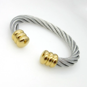 Detailed macro view of the twisted cable texture on a two-tone steel cuff bracelet