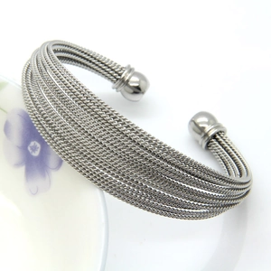 Macro shot of silver stainless steel twisted wire layered open bangle with sphere ends