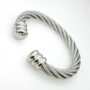 Detail of silver twisted cable cuff bracelet featuring polished triple ball end caps