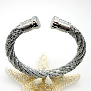 Detailed view of silver twisted cable cuff bangle with smooth cylindrical end caps