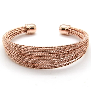 Detail of rose gold multi-strand twisted wire cable open cuff bracelet with polished ends