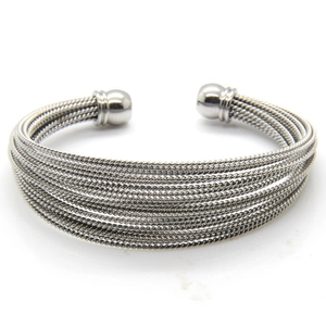 Detail of silver twisted wire open bangle featuring multi-layer texture and ball ends