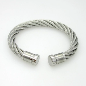 Macro detail of twisted titanium steel cable bracelet with cylindrical end caps