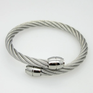 Macro detail of silver twisted cable cuff bracelet with smooth cylindrical metal end caps
