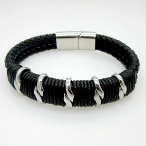 Close-up of black braided leather men's bracelet with a silver magnetic metal clasp