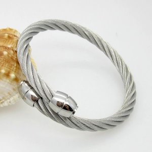 Macro view of cable twisted stainless steel open bangle with polished cylinder ends