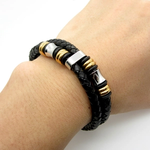 Men's double-layered braided leather bracelet with gold and silver metal accents on wrist