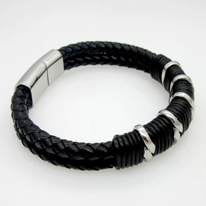 Close-up of double-layer black braided leather bracelet with silver steel magnetic clasp