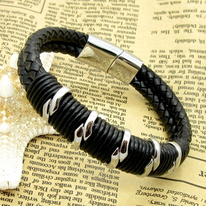 Macro shot of men's double-layer braided leather bracelet with silver metal rings