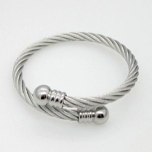 Detailed macro view of silver twisted steel cable bracelet with polished ball ends