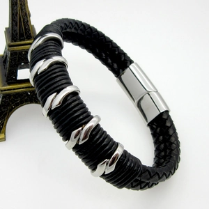 Macro shot of men's double-layer black braided leather bracelet with silver metal rings