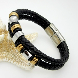 Detail of double-strand braided leather bracelet with gold and silver beads and magnetic clasp