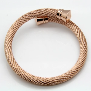 Detail shot of rose gold cable open bangle with spiral texture and tapered end caps