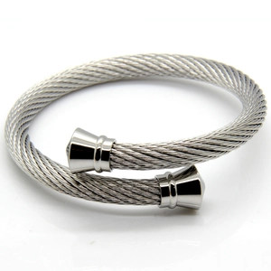 Macro shot of silver twisted cable cuff bracelet with polished metal cone end caps
