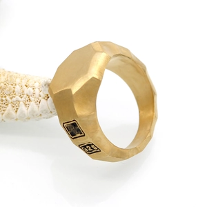 Brushed gold geometric hexagon wide ring in 316L titanium steel shown on a starfish