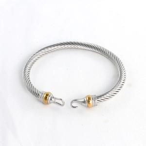 Two-tone stainless steel cable wire twisted cuff bracelet with a gold accent hook clasp