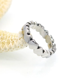 Polished 925 sterling silver ring with interlocking heart design on natural starfish