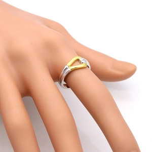 Bamboo style two-tone 925 silver knot ring on model hand with minimalist white background