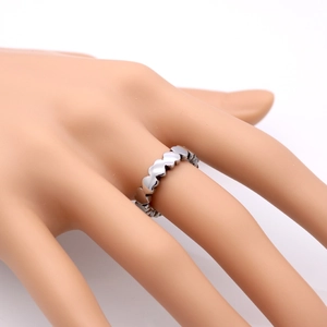 Polished stainless steel band ring featuring continuous heart-shaped link pattern