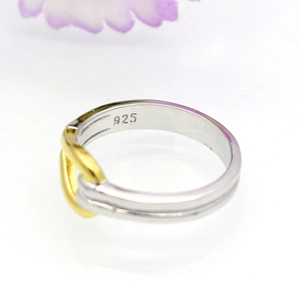 Detailed macro view of silver bamboo knot ring with S925 hallmark and gold rope accent