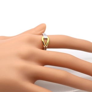 Close-up of dual-tone bamboo knot ring in silver and gold on a model finger