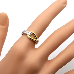 Detail of two-tone U-link bamboo ring in polished silver and gold finish on finger