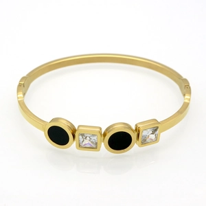Detailed shot of gold-plated titanium steel bracelet with black rounds and square zircons