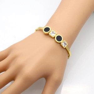 Gold plated titanium steel bangle with double square diamonds and black round inlay