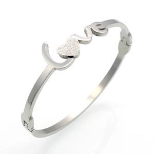Macro shot of silver metal LOVE bracelet featuring a matte heart detail and hollow letters