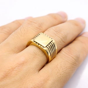 Minimalist gold square signet ring for men with vertical side grooves shown on hand