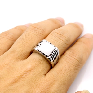 Men's minimalist silver square signet ring with white stone inlay on hand