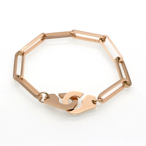 Polished rose gold paperclip chain bracelet featuring a detailed handcuff charm clasp