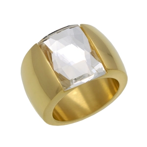 Detailed close-up of a wide gold-plated ring with a large rectangular clear crystal stone